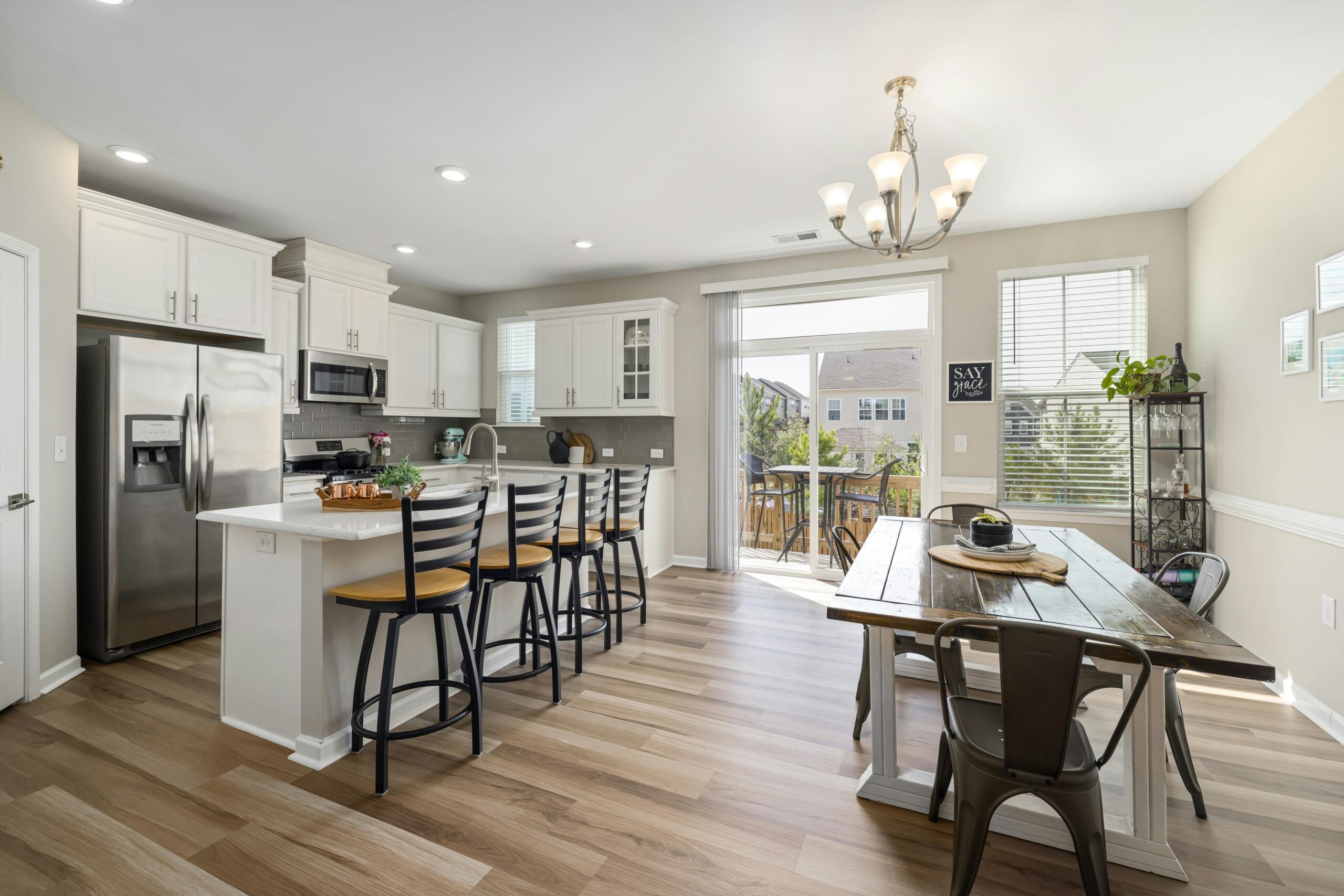 Modern open-plan kitchen and dining space with stylish furnishings and bright natural light.
