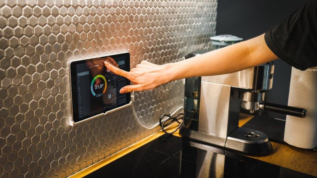 Smart home upgrade: person using a smart switch in a stylish kitchen