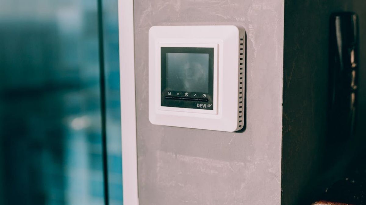 Wall-mounted smart thermostat in a modern home interior